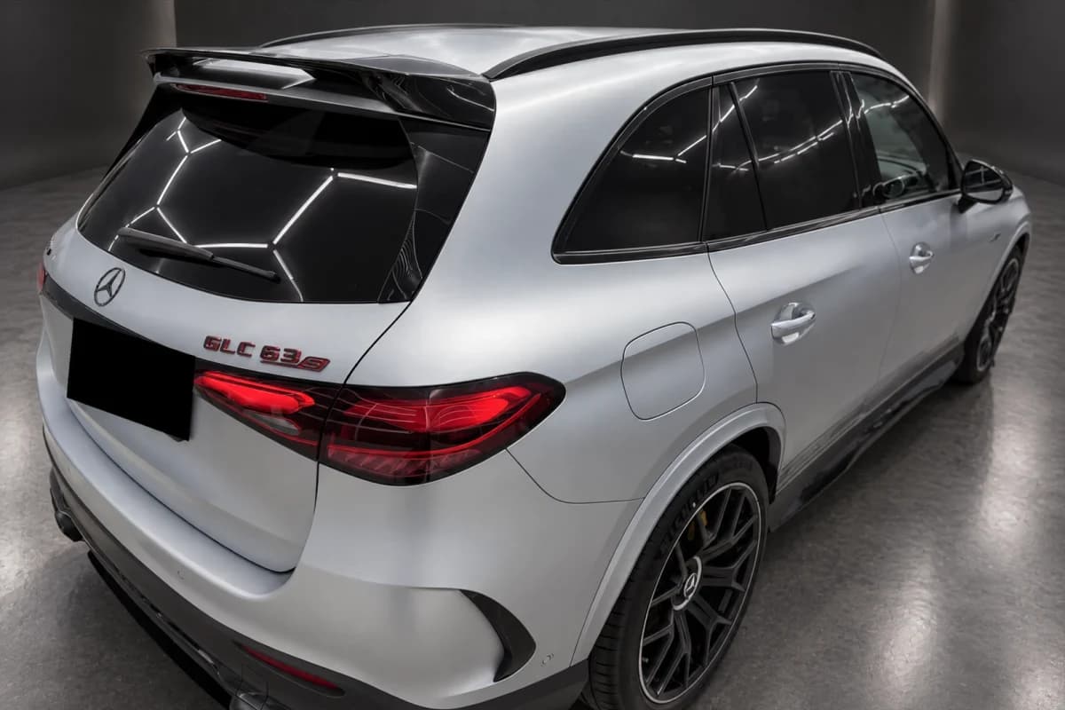 Mercedes-AMG GLC 63, rear three-quarter view: parking-lot photo, then the same shot in the studio